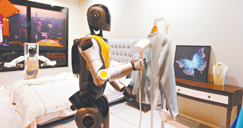 图片202月24日,汉产机器人亮相全市科技创新大会。图为光子机器人自主熨烫衣物,扫床机器人清洁床铺。